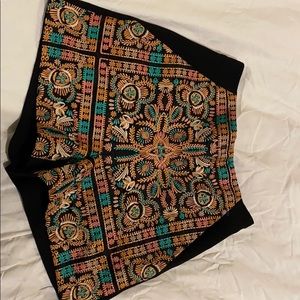 Embroidered black shorts.